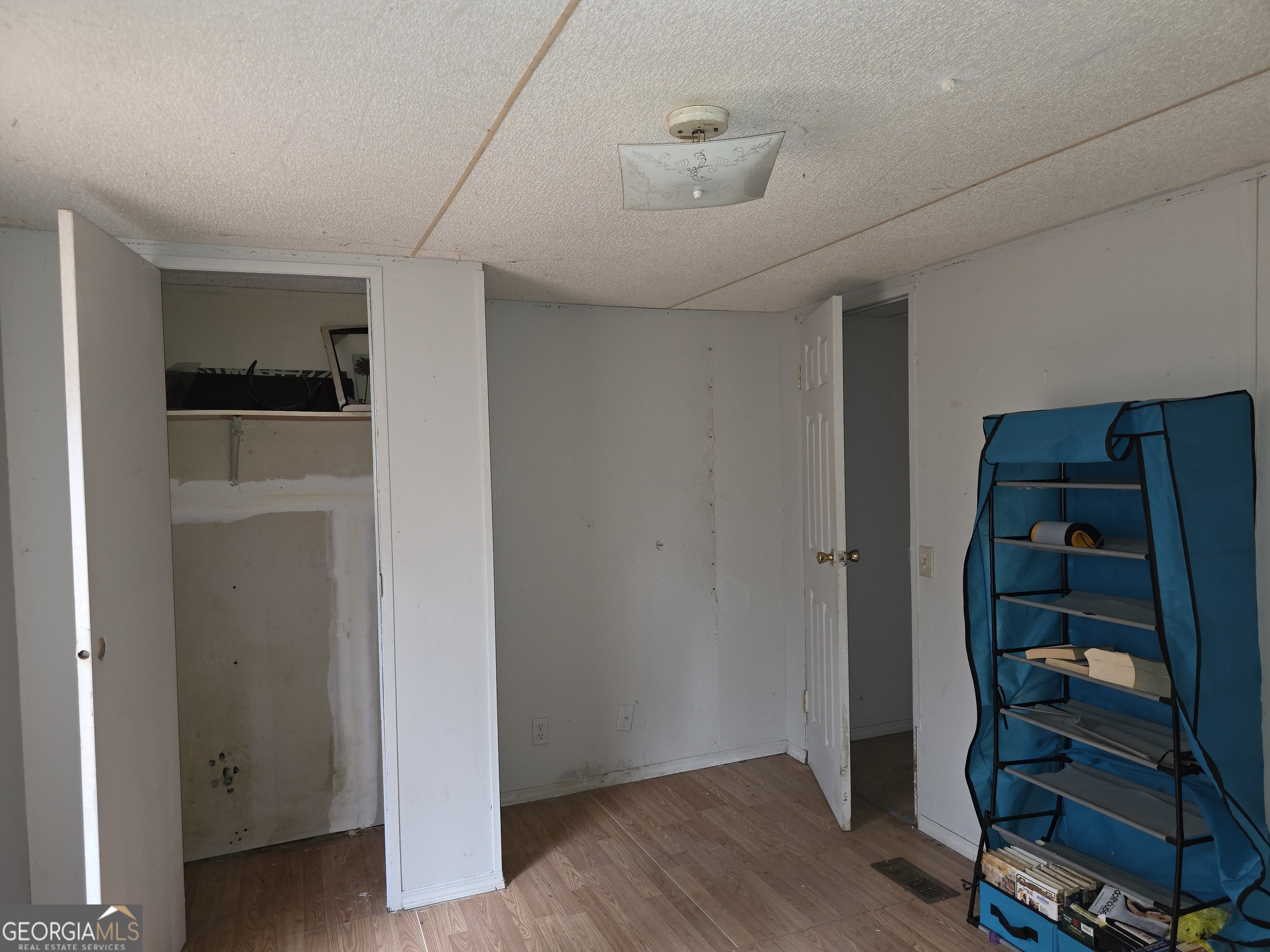 650 Wildcat Road Buchanan, GA 30113 - Photo 17 of 26 a view of an empty room with wooden floor and closet