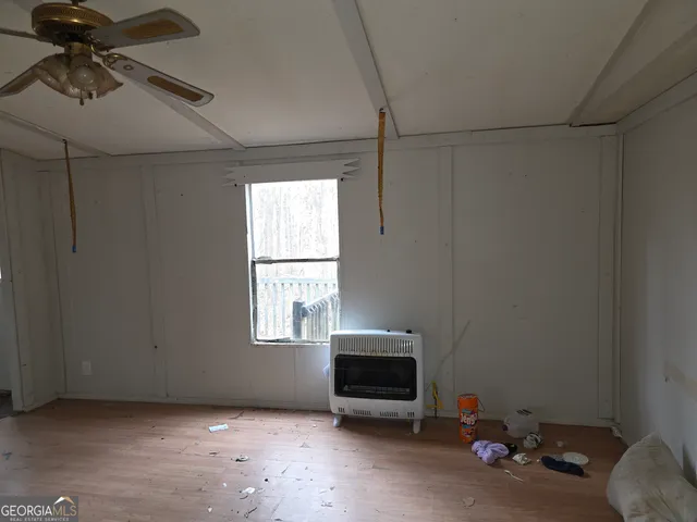a view of empty room with a fireplace