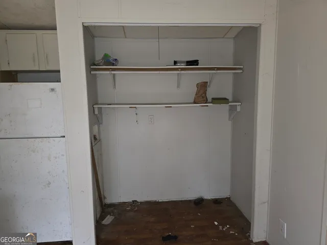 a view of storage and utility room with racks on the wall