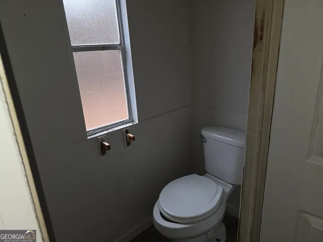 a white toilet sitting next to a sink