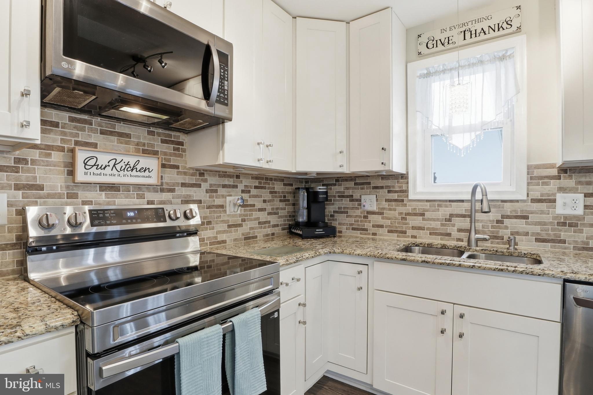 1025 White Oak Road Windsor, PA 17366 - Photo 12 of 70 a kitchen with stainless steel appliances granite countertop a sink a stove and a microwave