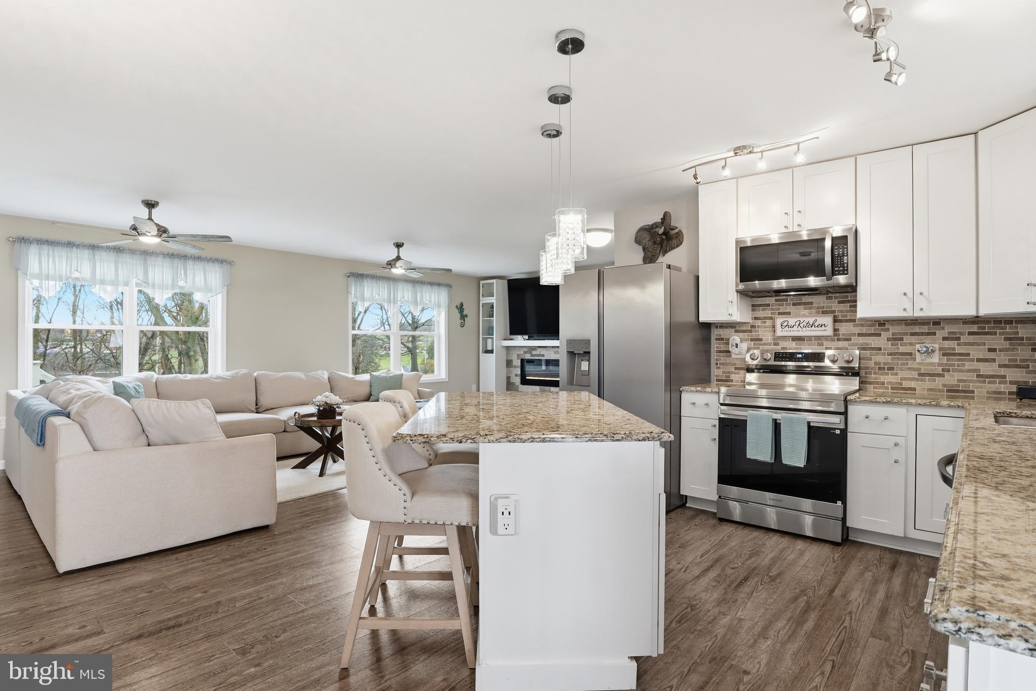 1025 White Oak Road Windsor, PA 17366 - Photo 14 of 70 a living room with stainless steel appliances kitchen island granite countertop a stove and a refrigerator