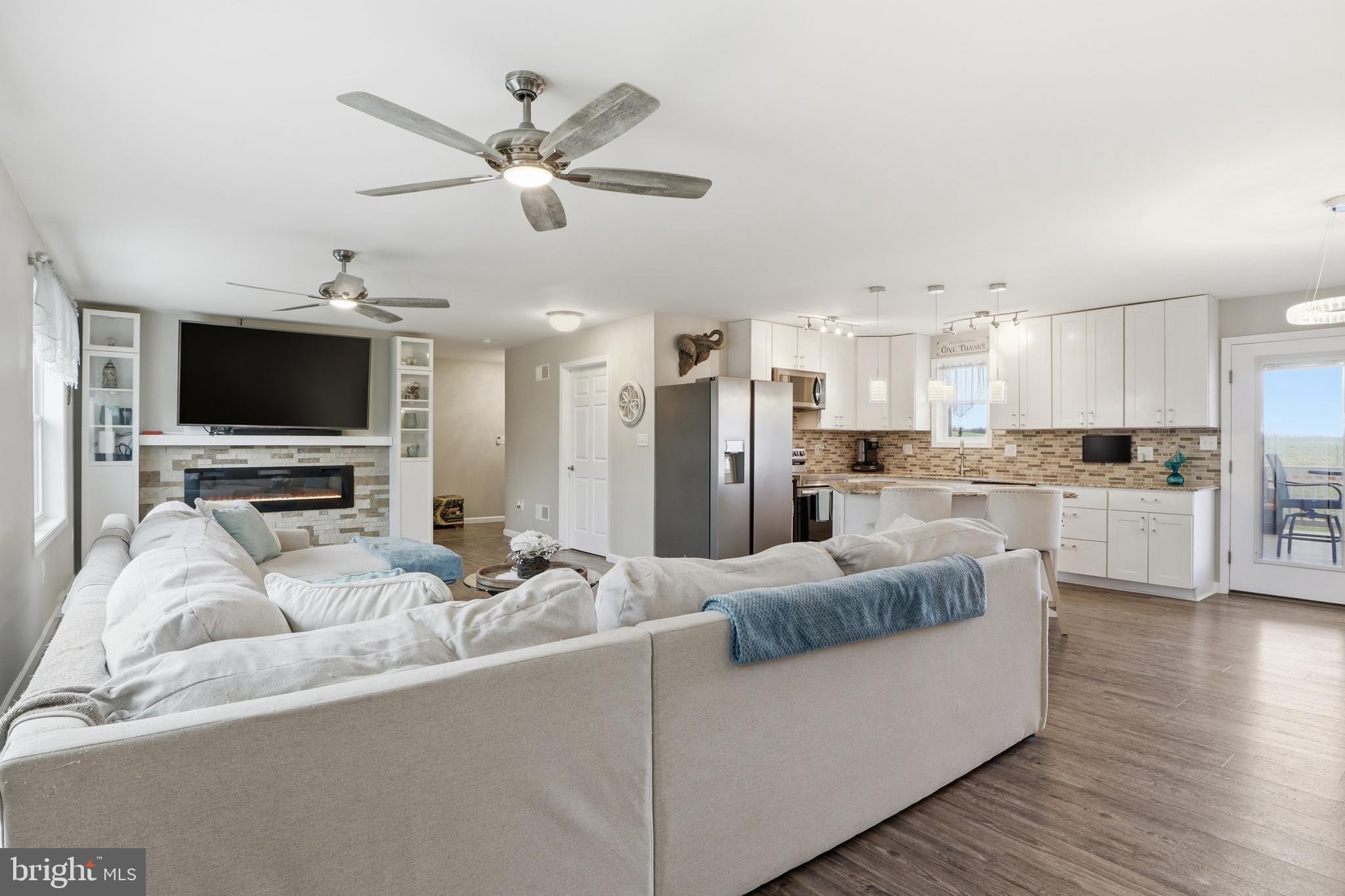 1025 White Oak Road Windsor, PA 17366 - Photo 70 of 70 a living room with furniture and a flat screen tv with kitchen view