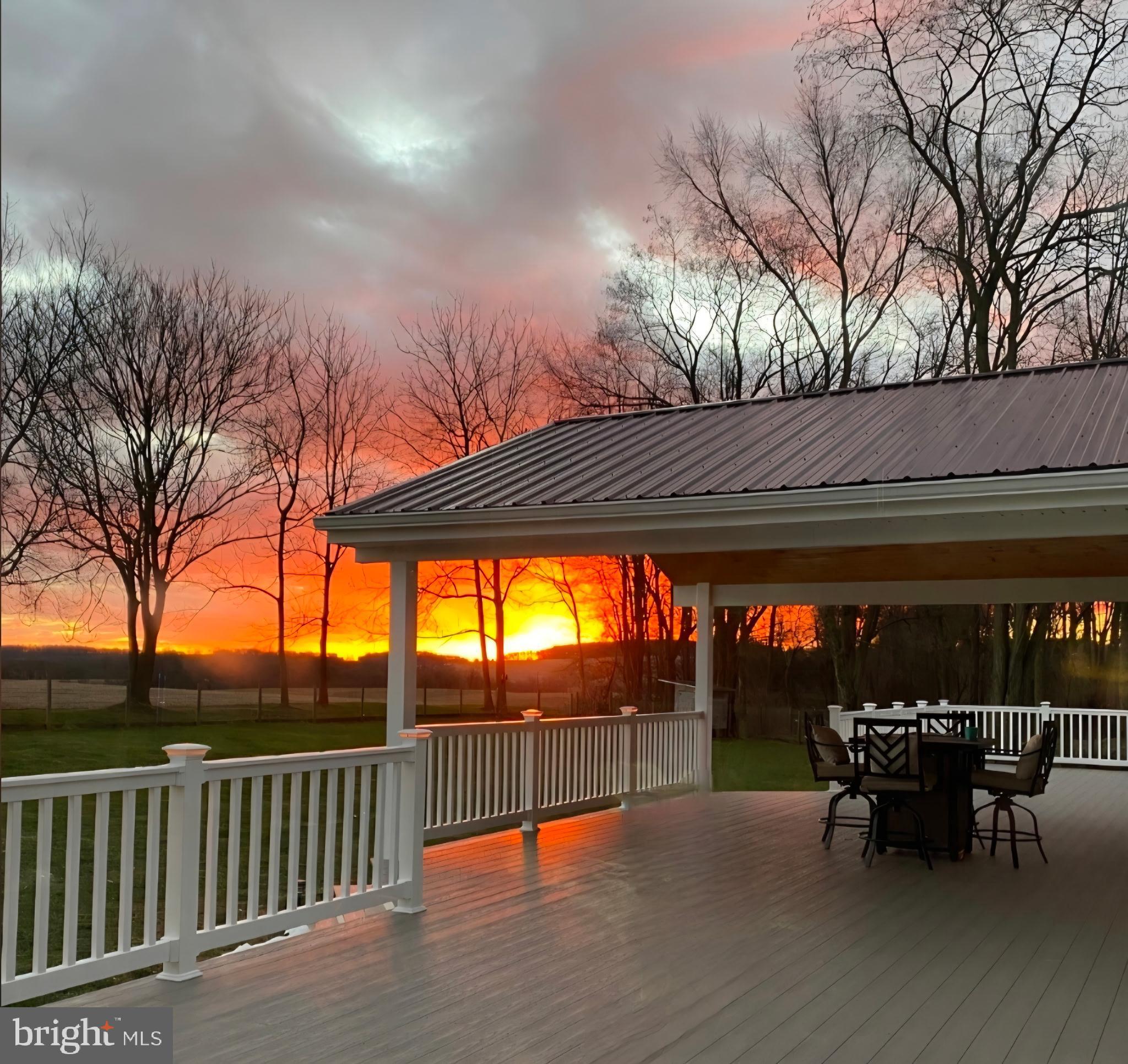 1025 White Oak Road Windsor, PA 17366 - Photo 64 of 70 a view of a patio with table and chairs under an umbrella with wooden floor