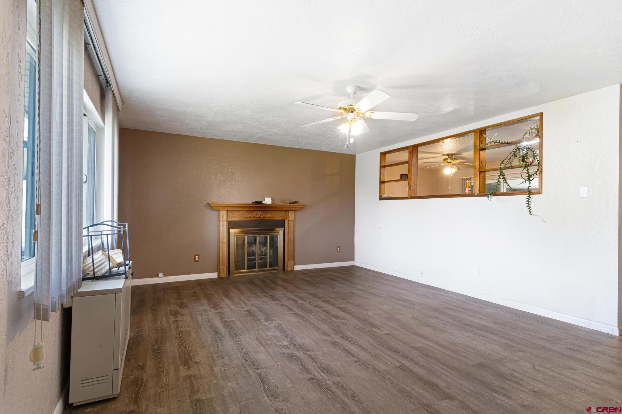 60918 Gunnison Road Montrose, CO 81401 - Photo 14 of 37 a view of an empty room with window and wooden floor