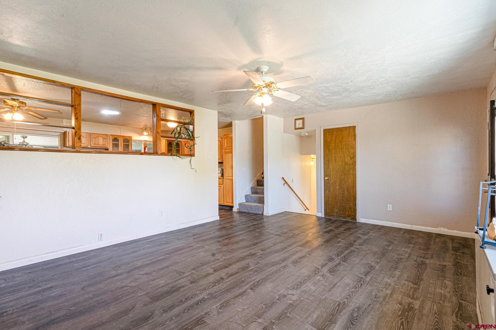 60918 Gunnison Road Montrose, CO 81401 - Photo 15 of 37 a view of an empty room with window and wooden floor