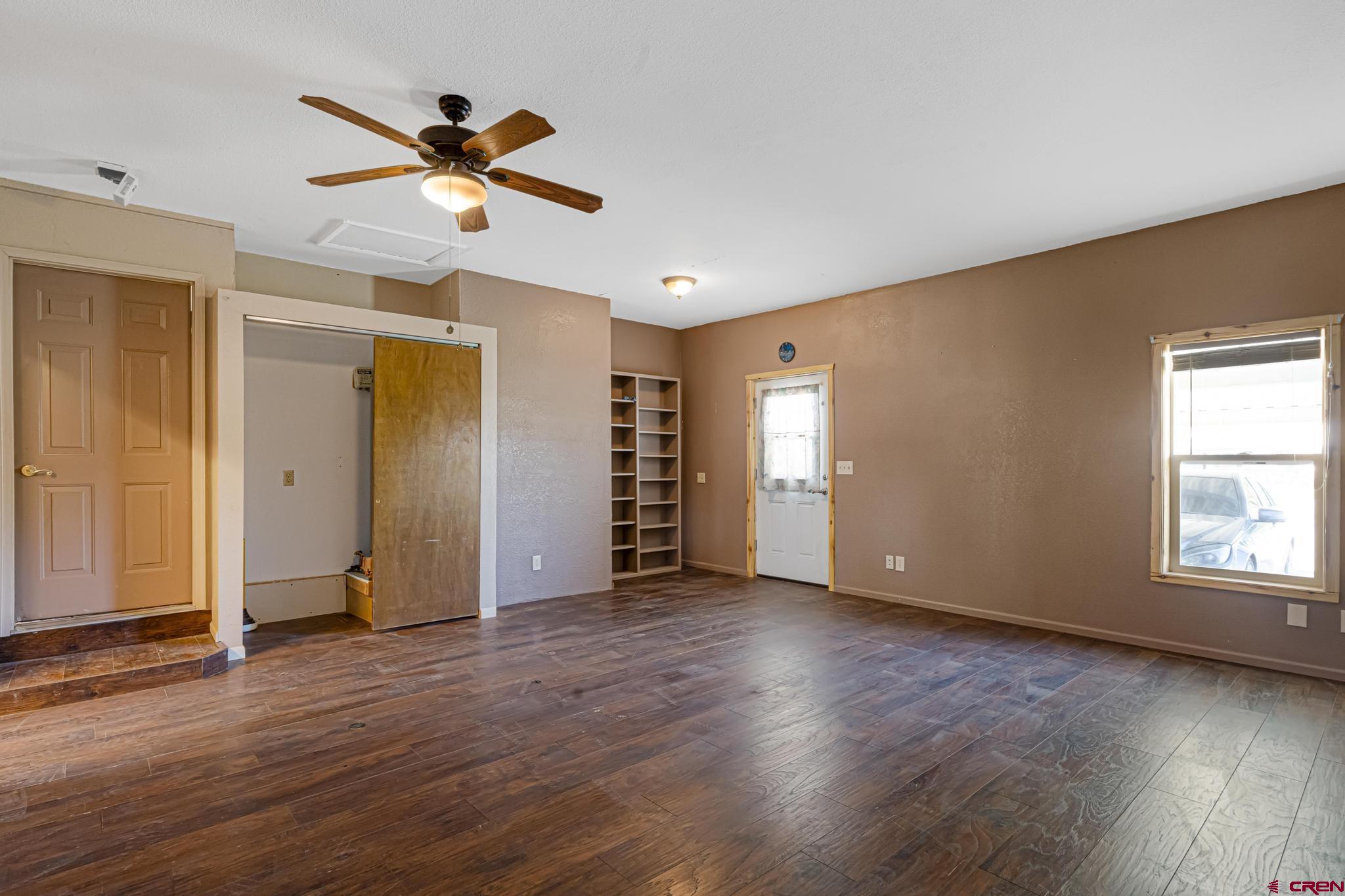 60918 Gunnison Road Montrose, CO 81401 - Photo 19 of 37 an empty room with wooden floor closet and windows