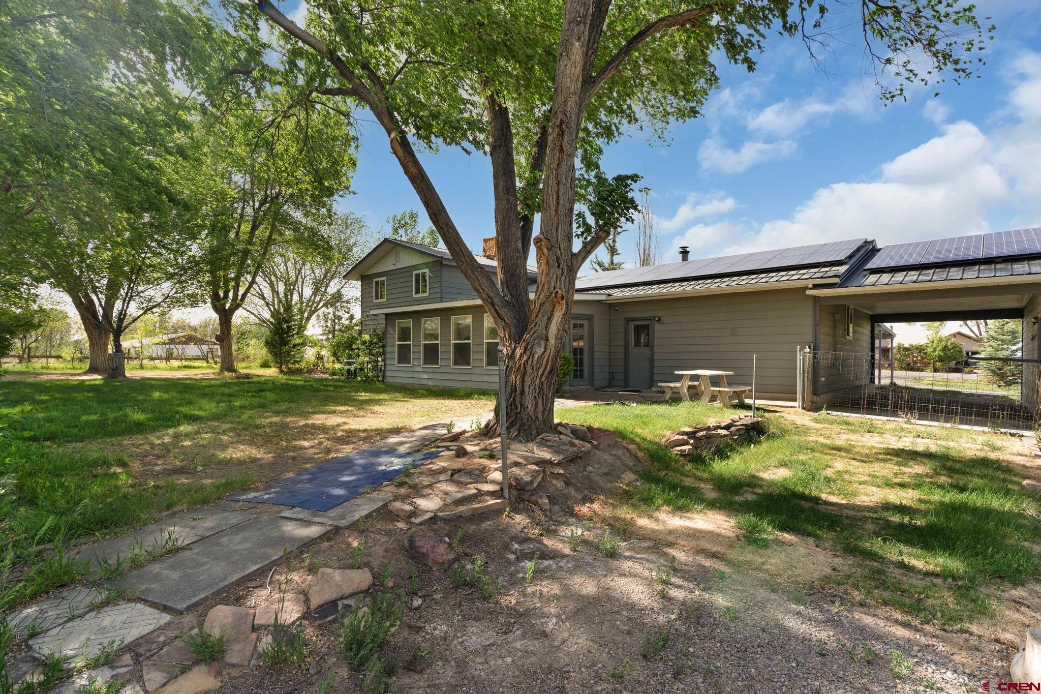 60918 Gunnison Road Montrose, CO 81401 - Photo 2 of 37 a view of a house with backyard and a tree