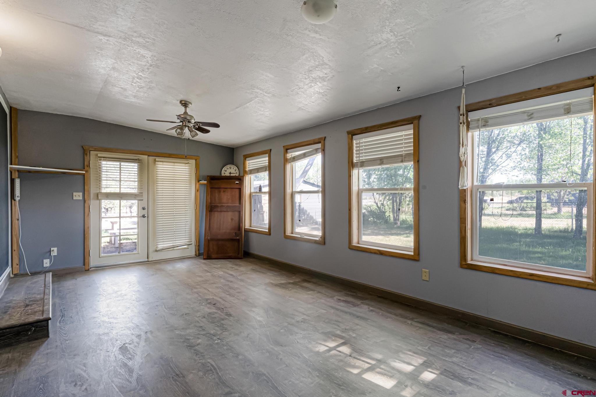60918 Gunnison Road Montrose, CO 81401 - Photo 22 of 37 a view of an empty room with a window and wooden floor