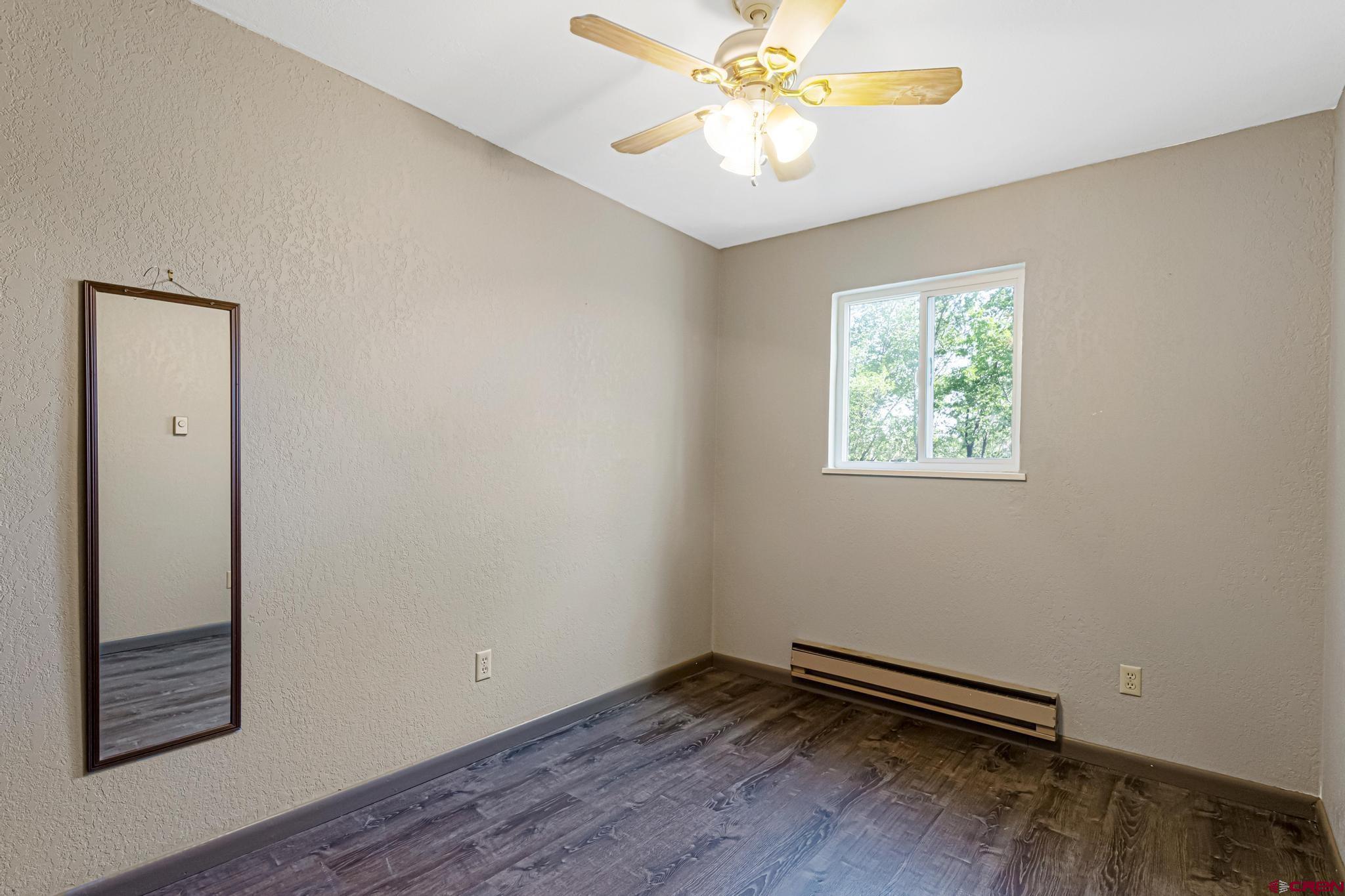 60918 Gunnison Road Montrose, CO 81401 - Photo 24 of 37 wooden floor in an empty room with a window