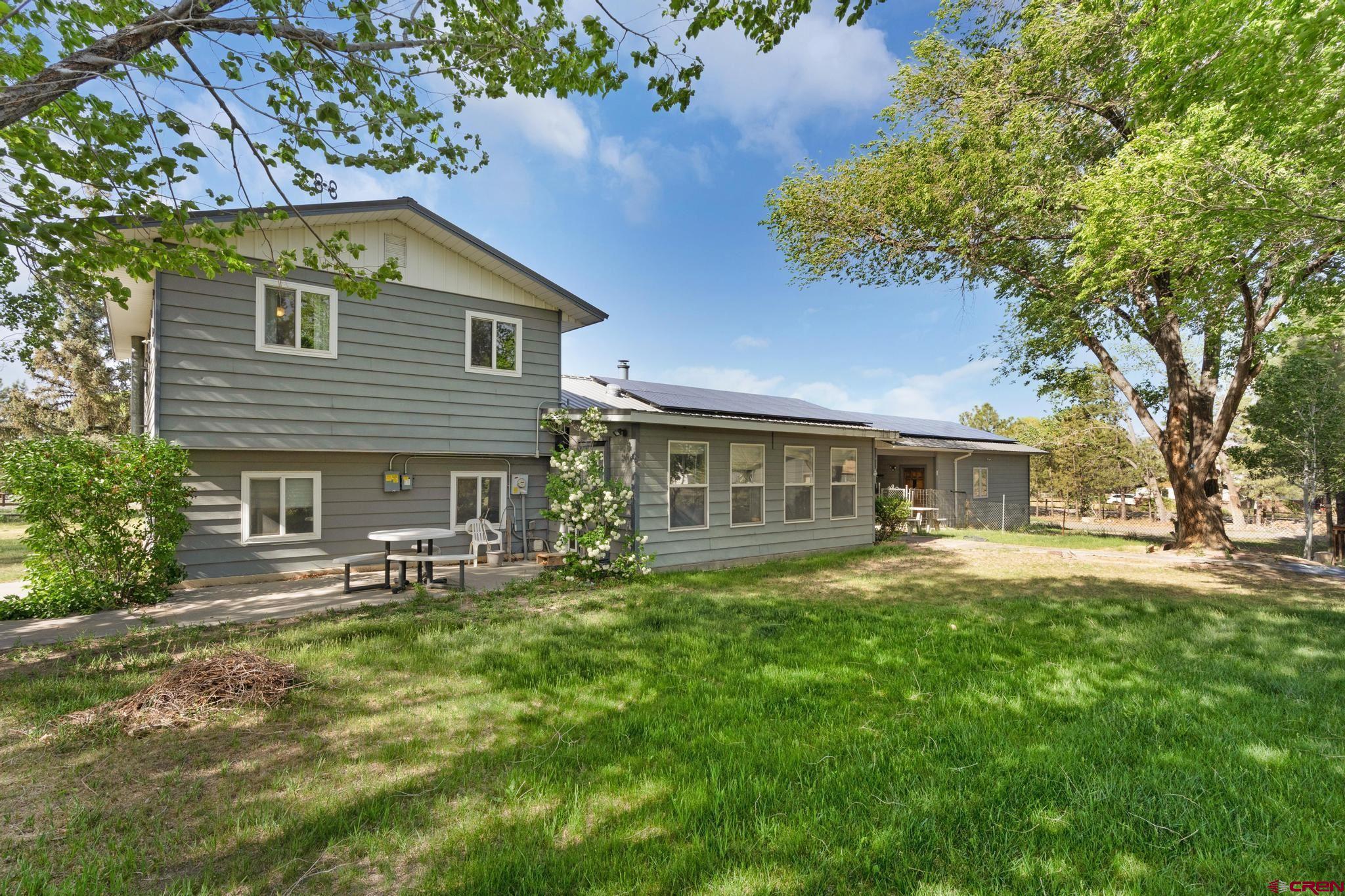 60918 Gunnison Road Montrose, CO 81401 - Photo 3 of 37 a front view of house with yard and green space