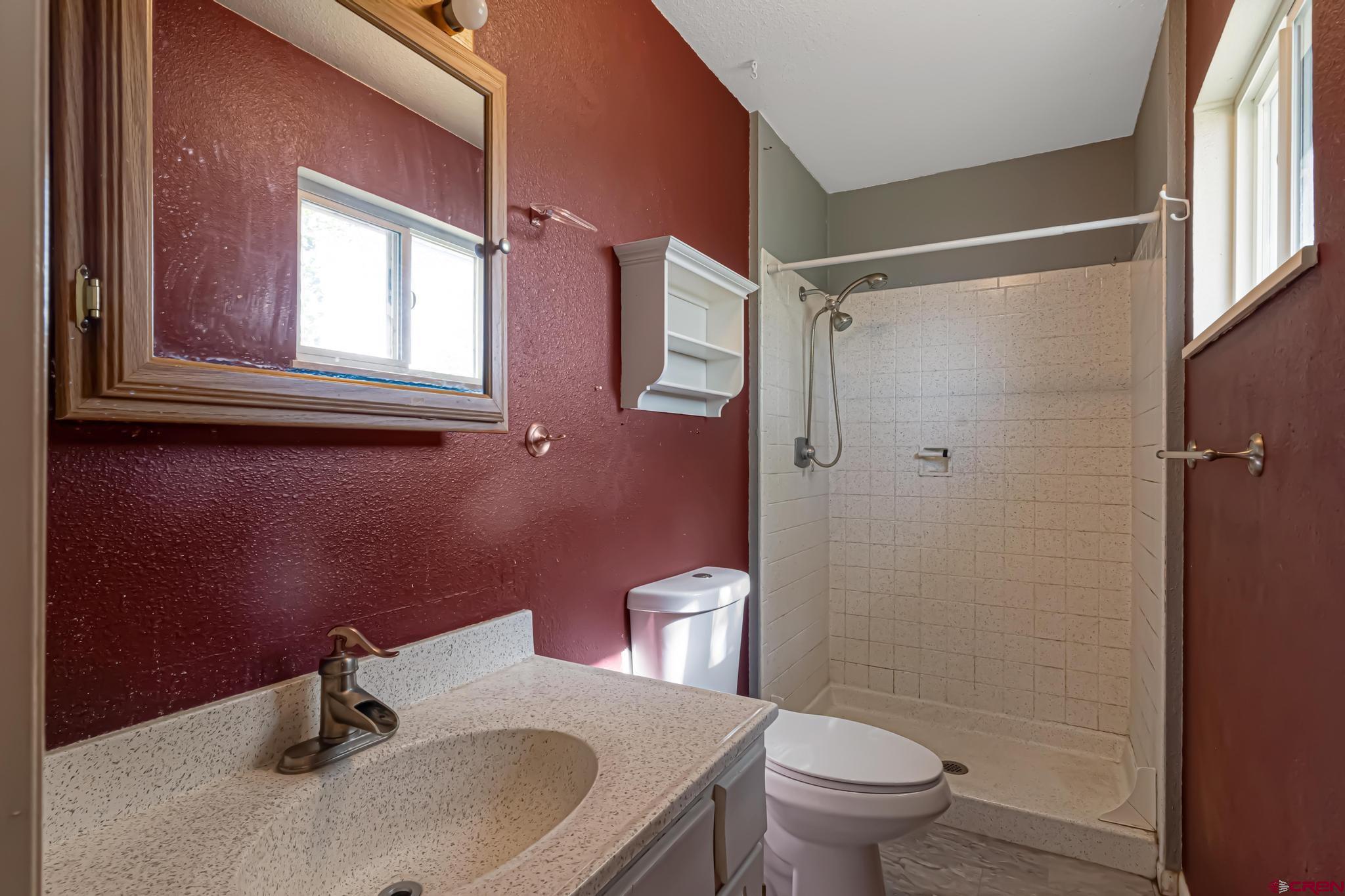 60918 Gunnison Road Montrose, CO 81401 - Photo 31 of 37 a bathroom with a sink a toilet and a mirror