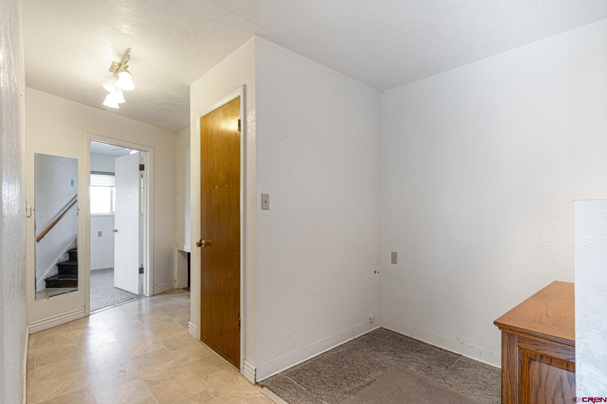 60918 Gunnison Road Montrose, CO 81401 - Photo 33 of 37 a view of a livingroom with wooden floor and a staircase