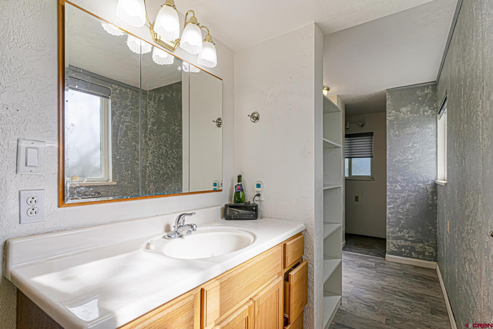 60918 Gunnison Road Montrose, CO 81401 - Photo 37 of 37 a bathroom with a sink a mirror and a shower