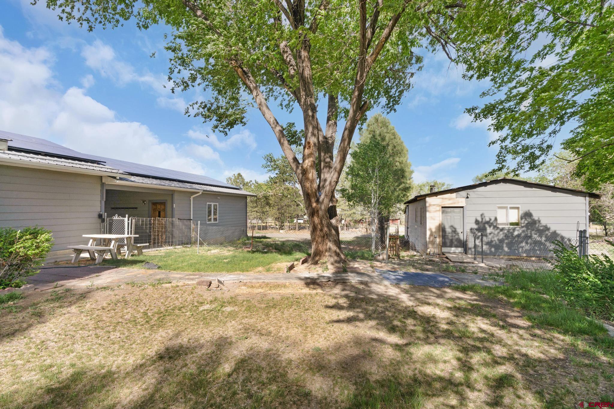 60918 Gunnison Road Montrose, CO 81401 - Photo 7 of 37 a front view of a house with a yard