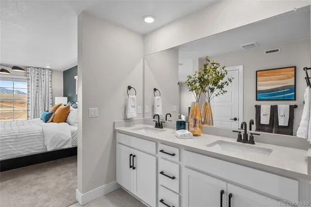 a bedroom with a bed and chandelier