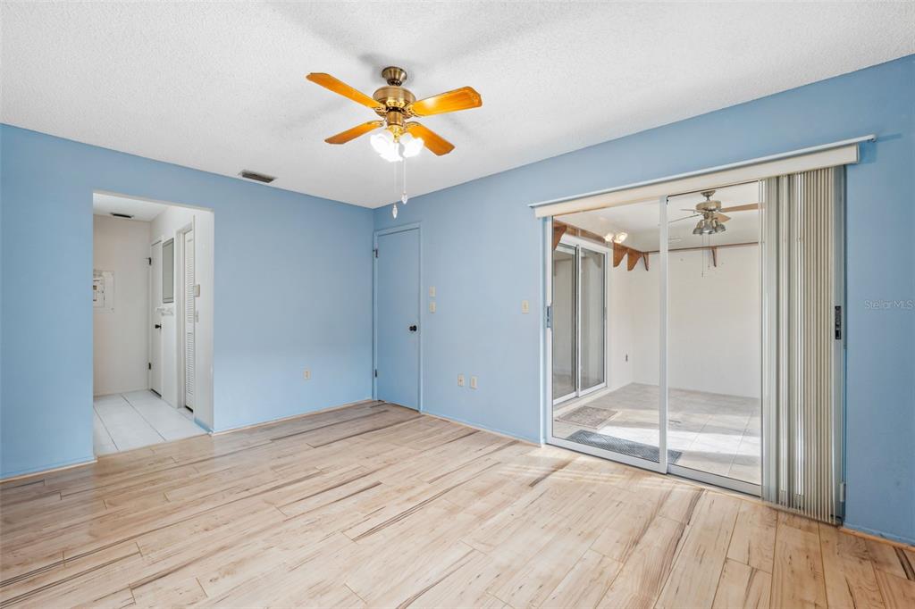 6506 Remus Drive New Port Richey, FL 34653 - Photo 12 of 32 a view of empty room with wooden floor and fan