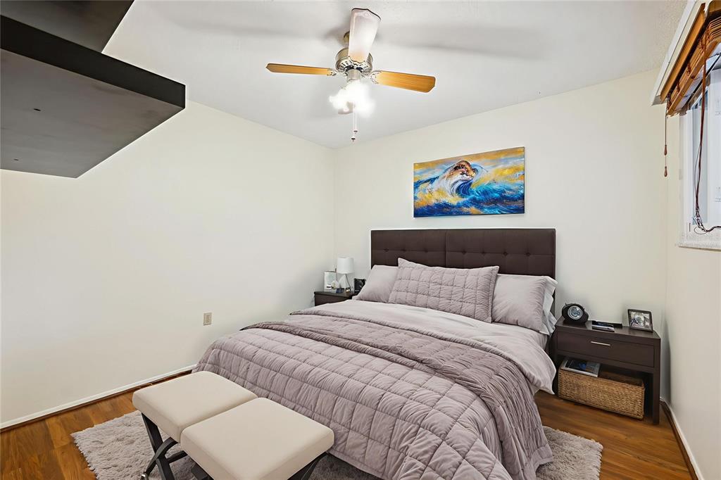 6506 Remus Drive New Port Richey, FL 34653 - Photo 15 of 32 a bedroom with a bed and a chandelier