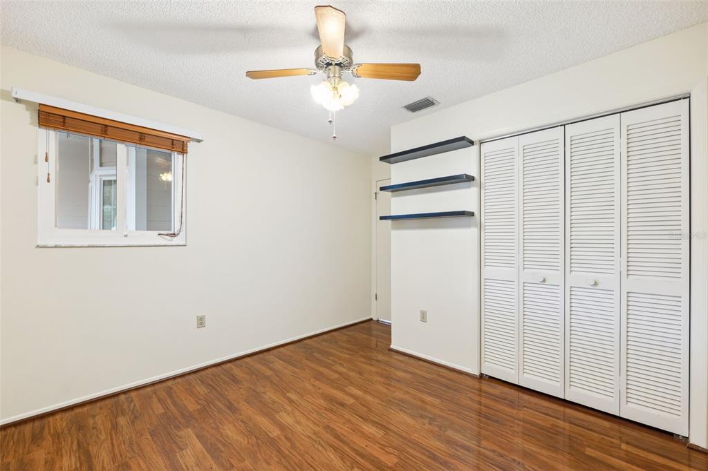 6506 Remus Drive New Port Richey, FL 34653 - Photo 16 of 32 wooden floor in an empty room with a window