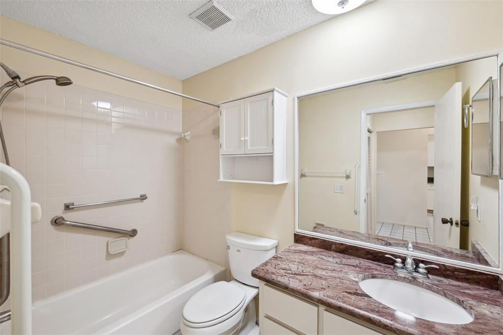 6506 Remus Drive New Port Richey, FL 34653 - Photo 17 of 32 a bathroom with a granite countertop sink toilet and shower