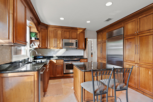 372 Stratford Road Des Plaines, IL 60016 - Photo 4 of 13 a kitchen with stainless steel appliances granite countertop a stove top oven a sink and a refrigerator