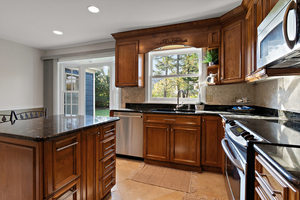 372 Stratford Road Des Plaines, IL 60016 - Photo 5 of 13 a kitchen with stainless steel appliances granite countertop a sink stove and cabinets
