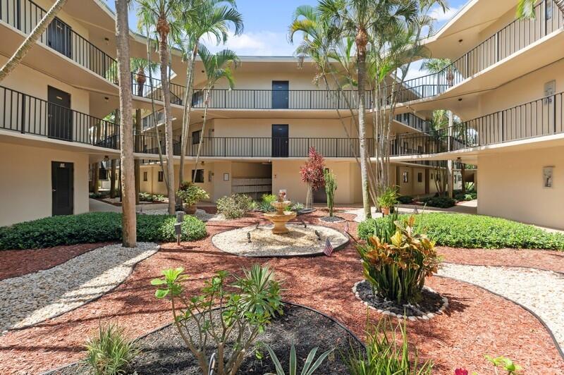 5370 Las Verdes Circle, Unit 201 Delray Beach, FL 33484 - Photo 1 of 21 a view of a house with a yard