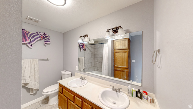 630 1100 West Provo, UT 84601 - Photo 22 of 64 Double vanity with undermount sinks and wood-finish cabinetry