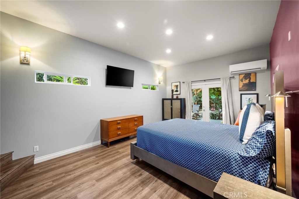 3441 Virginia Road Los Angeles, CA 90016 - Photo 15 of 40 a bedroom with a bed and wooden floor