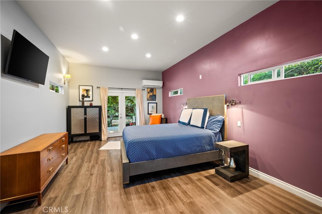 3441 Virginia Road Los Angeles, CA 90016 - Photo 17 of 40 a bedroom with a bed and a flat screen tv