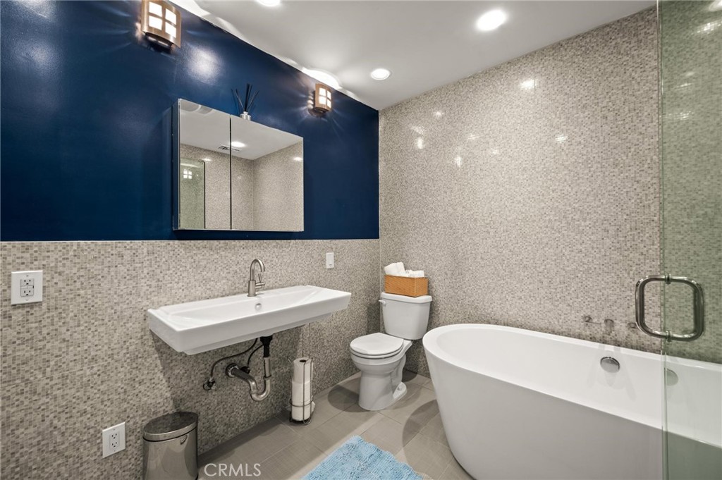 3441 Virginia Road Los Angeles, CA 90016 - Photo 19 of 40 a bathroom with a sink a toilet and a mirror