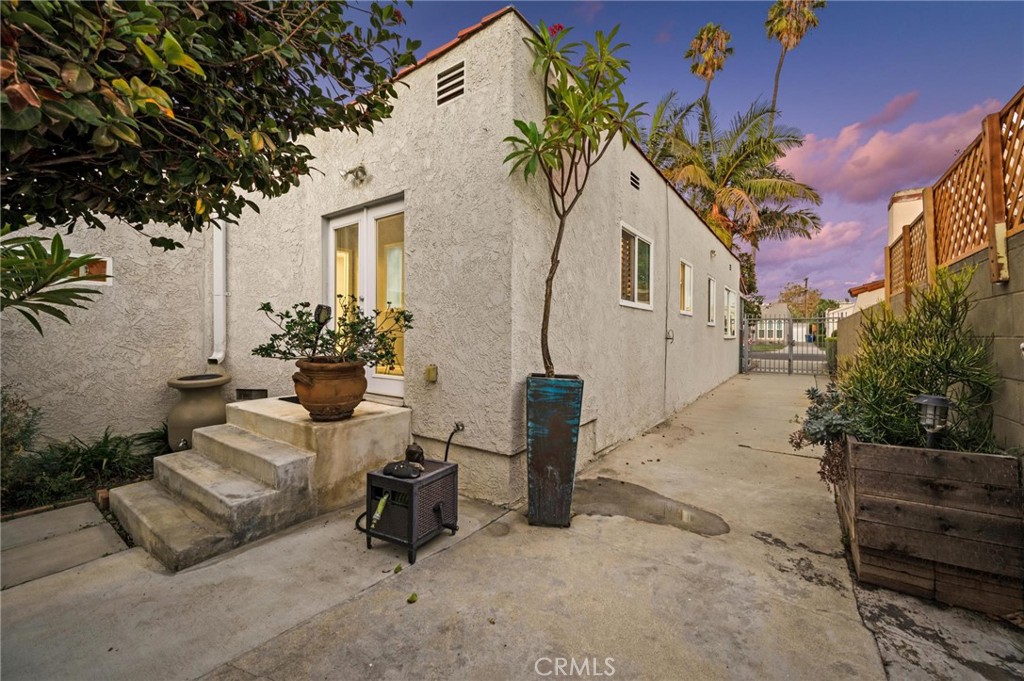 3441 Virginia Road Los Angeles, CA 90016 - Photo 31 of 40 a view of a patio with couches and a table and chairs under an umbrella