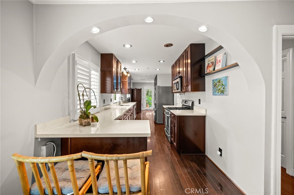 3441 Virginia Road Los Angeles, CA 90016 - Photo 7 of 40 a view of kitchen island with stainless steel appliances kitchen island sink stove and refrigerator