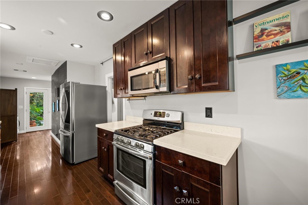 3441 Virginia Road Los Angeles, CA 90016 - Photo 10 of 40 a kitchen with stainless steel appliances granite countertop a stove refrigerator and microwave