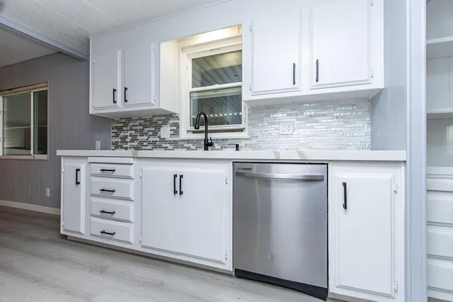 a kitchen with granite countertop cabinets and window
