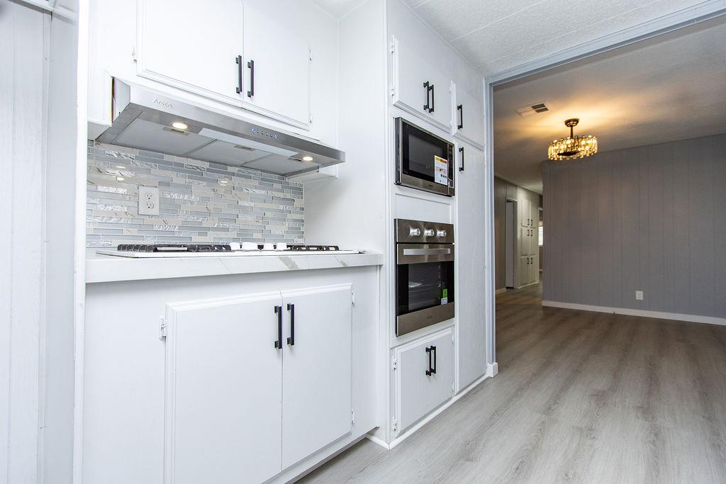 520 Allen Way Turlock, CA 95380 - Photo 12 of 39 a kitchen with stainless steel appliances granite countertop a stove a sink and a microwave