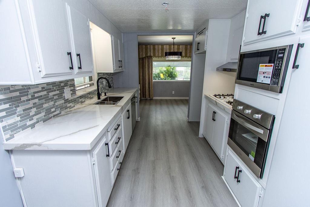 520 Allen Way Turlock, CA 95380 - Photo 13 of 39 a kitchen with stainless steel appliances granite countertop a stove and a sink