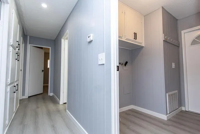 a view of a hallway with wooden floor