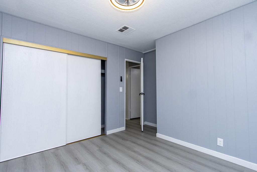 520 Allen Way Turlock, CA 95380 - Photo 24 of 39 a view of an empty room with wooden floor and a window