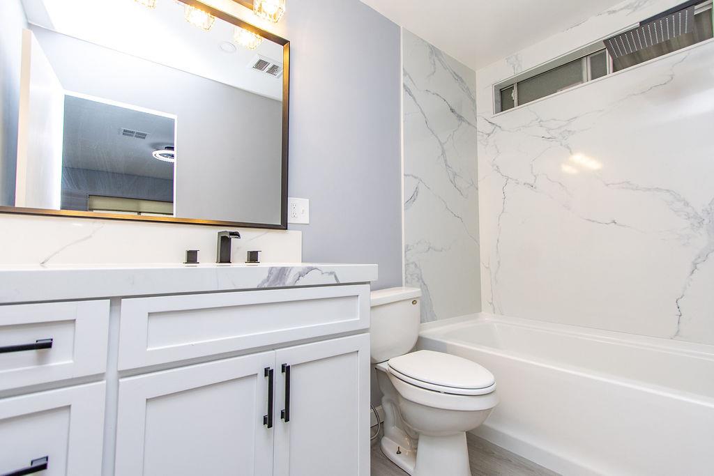 520 Allen Way Turlock, CA 95380 - Photo 27 of 39 a bathroom with a sink a toilet and a mirror