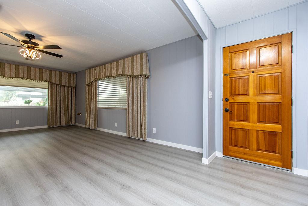 520 Allen Way Turlock, CA 95380 - Photo 3 of 39 an empty room with wooden floor cabinet and windows