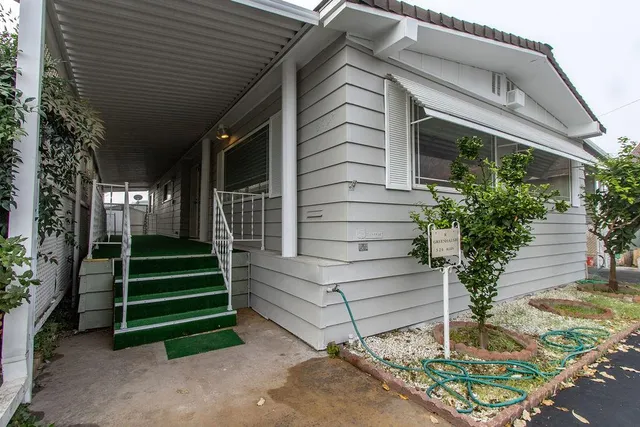 a front view of a house with a garden