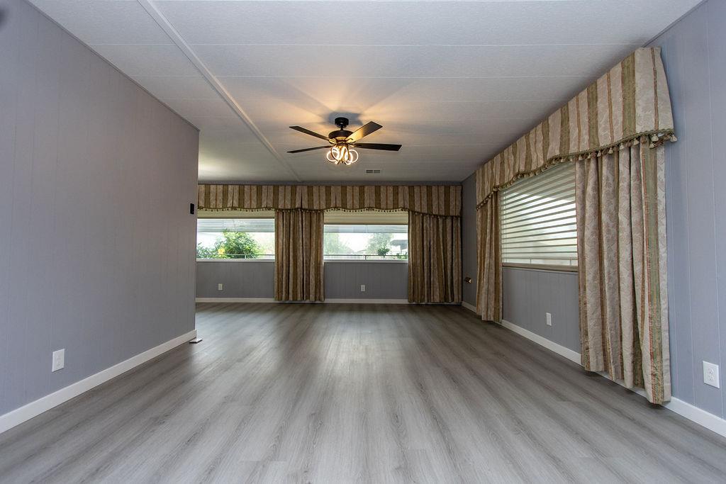 520 Allen Way Turlock, CA 95380 - Photo 4 of 39 a view of an empty room with a window and wooden floor