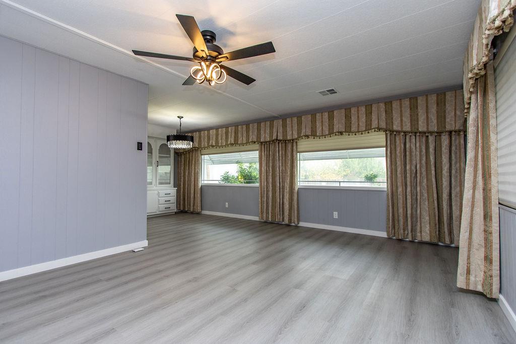 520 Allen Way Turlock, CA 95380 - Photo 5 of 39 a view of an empty room with a window and wooden floor