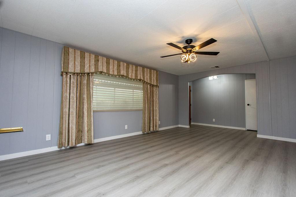 520 Allen Way Turlock, CA 95380 - Photo 7 of 39 wooden floor in an empty room with a window