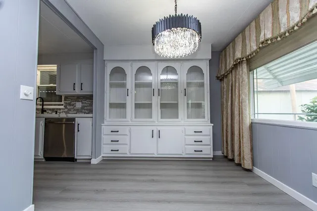 a view of kitchen with stainless steel appliances granite countertop a stove oven and a refrigerator
