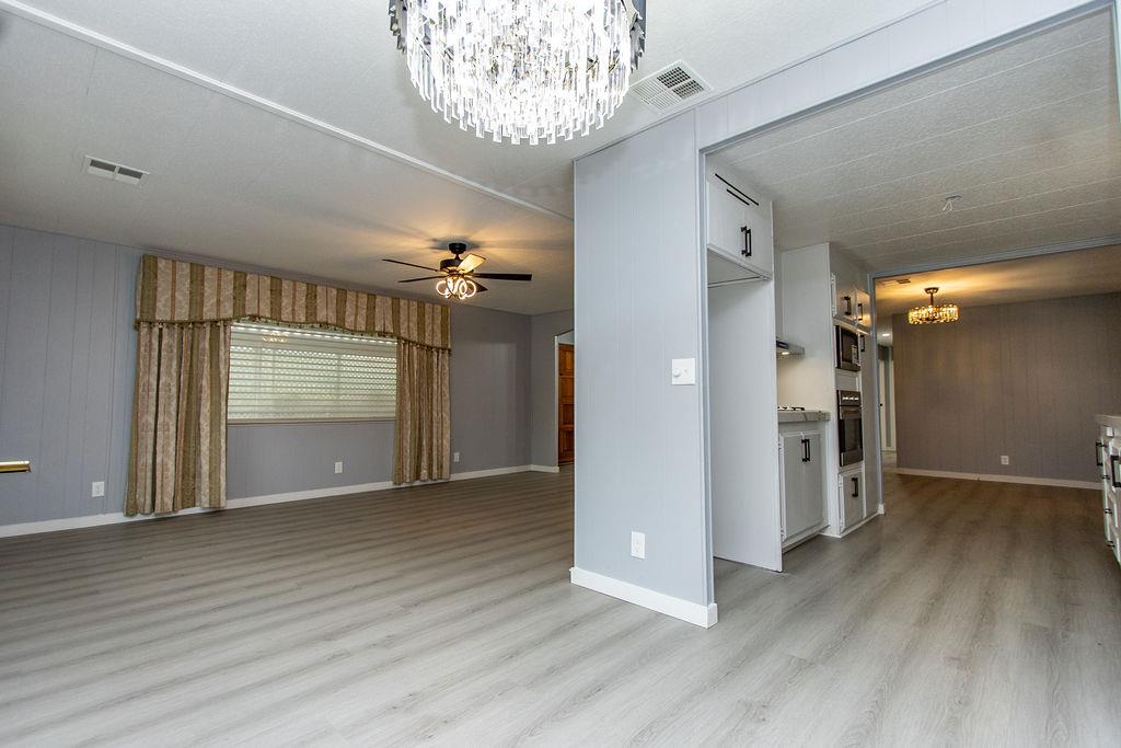 520 Allen Way Turlock, CA 95380 - Photo 9 of 39 wooden floor in an empty room with a window
