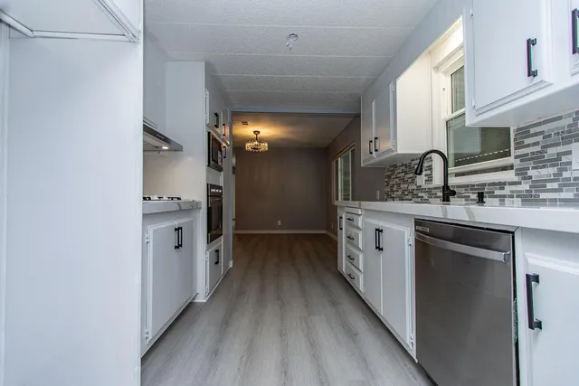 a kitchen with a sink and a refrigerator