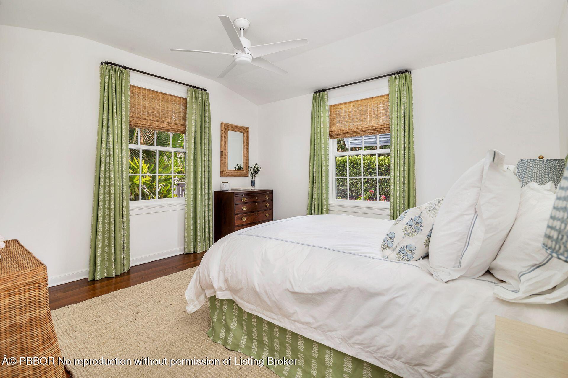 255 Colonial Lane Palm Beach, FL 33480 - Photo 20 of 32 a bedroom with a bed and wooden floor