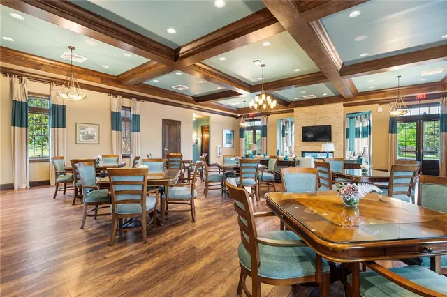 a view of a dining room with lots of furniture and wooden floor